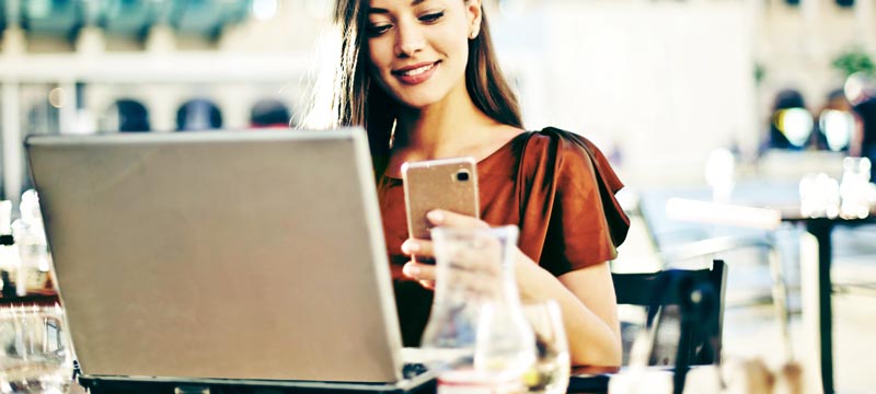 Woman with laptop and mobile phone